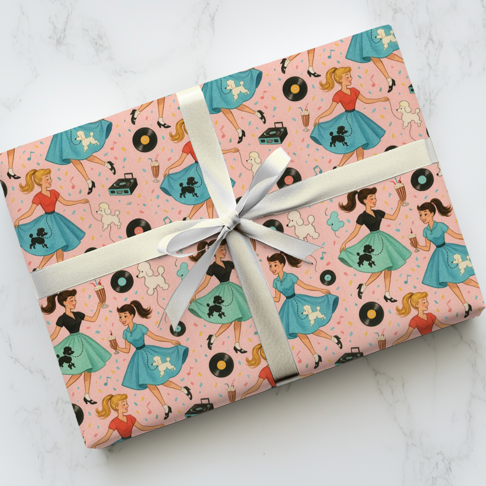 Gift wrapped in retro-themed paper featuring poodle skirts, jukebox and records, against a pink background.
