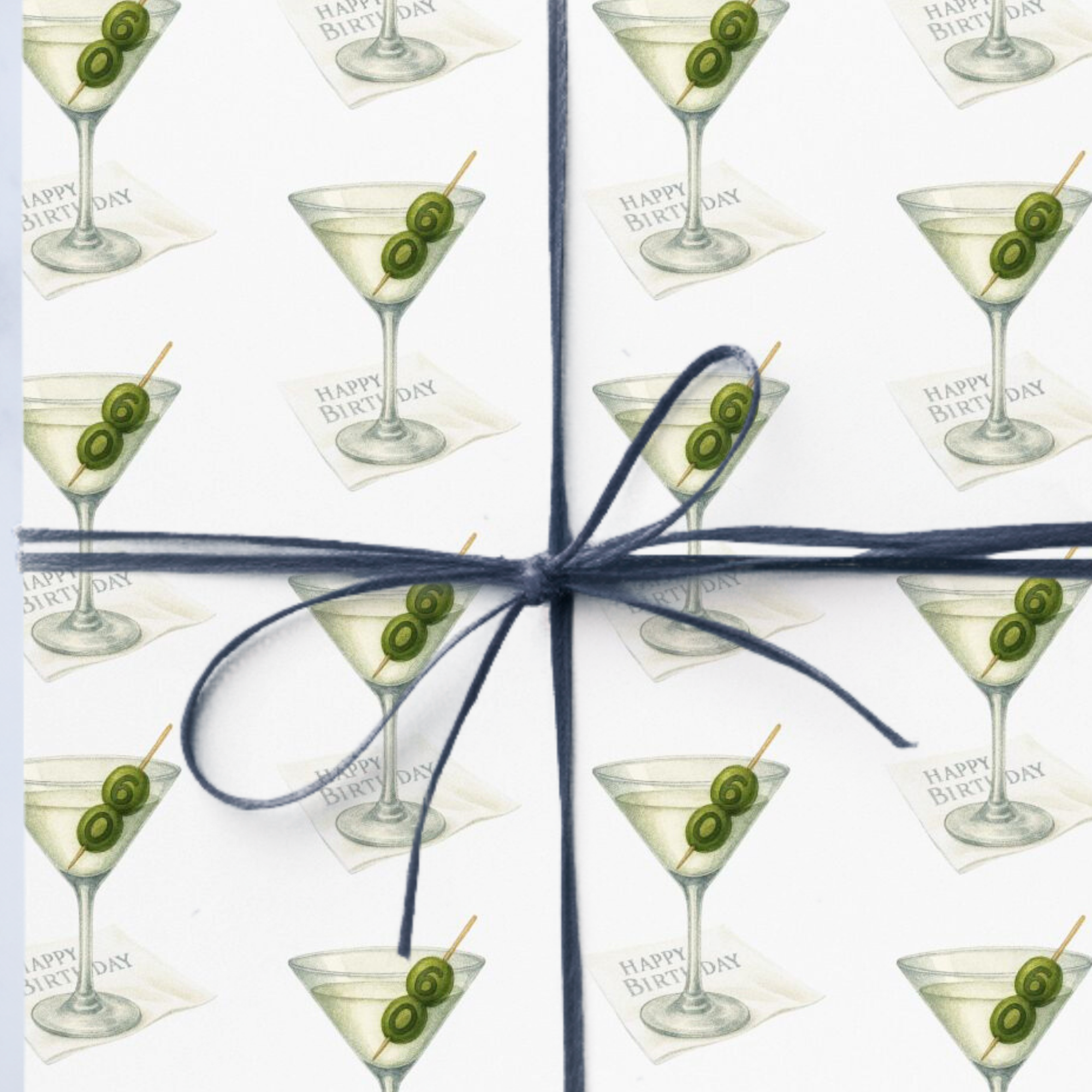 Wrapping Paper featuring a martini glass design and olives on a white background.