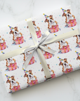 Birthday gift wrapping paper featuring an American bulldog in a party hat and present.
