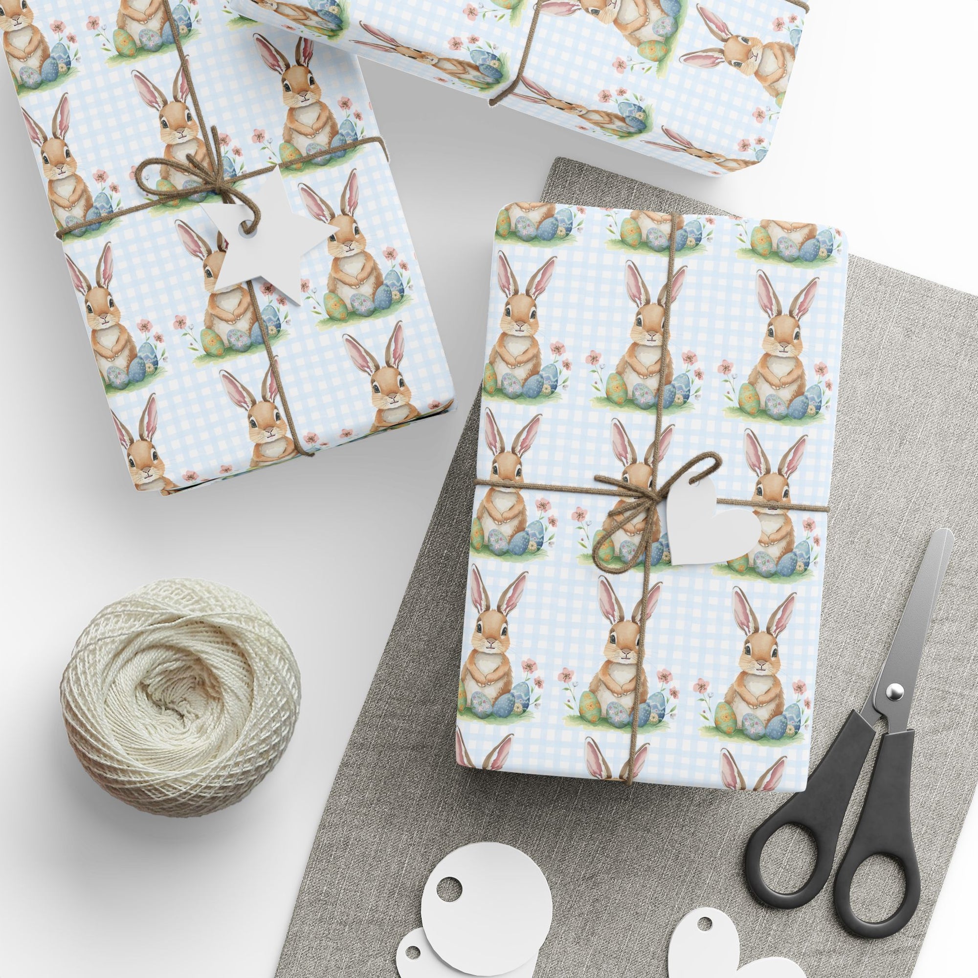 Gift boxes wrapped with bunny pattern with a blue gingham background