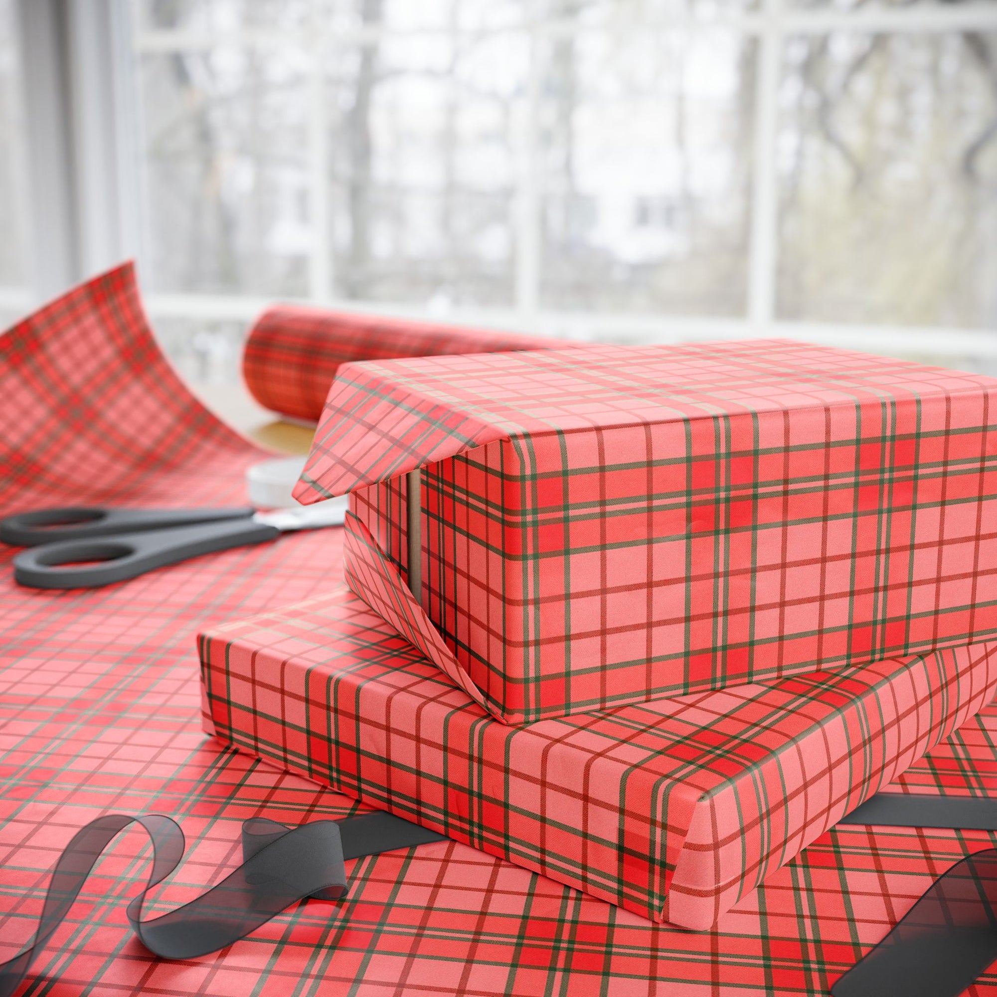 Red plaid gift wrap with scissors on a matching surface