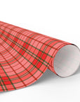 Roll of red plaid patterned paper on a white background