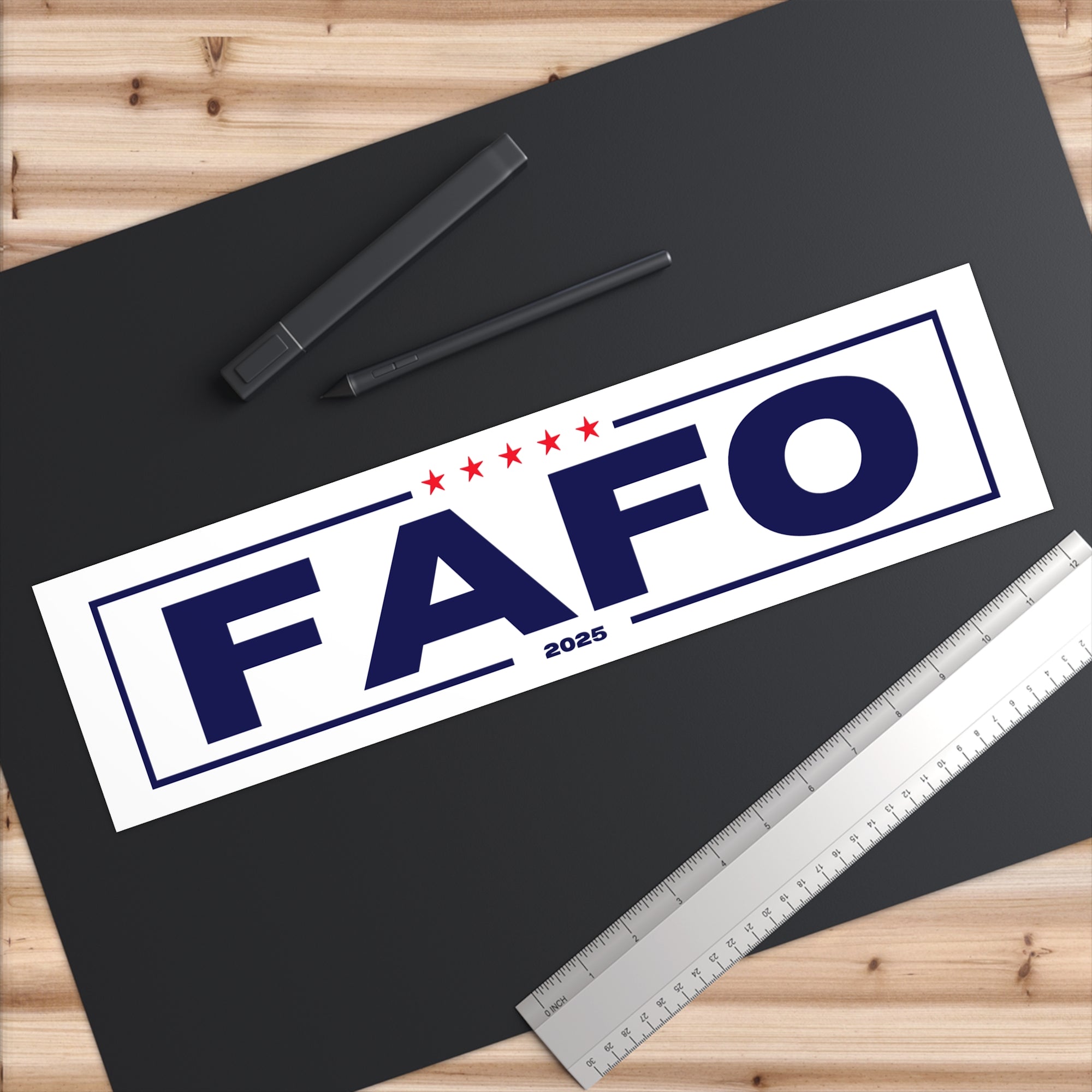 FAFO 2025 logo on a black surface with a ruler and pens.