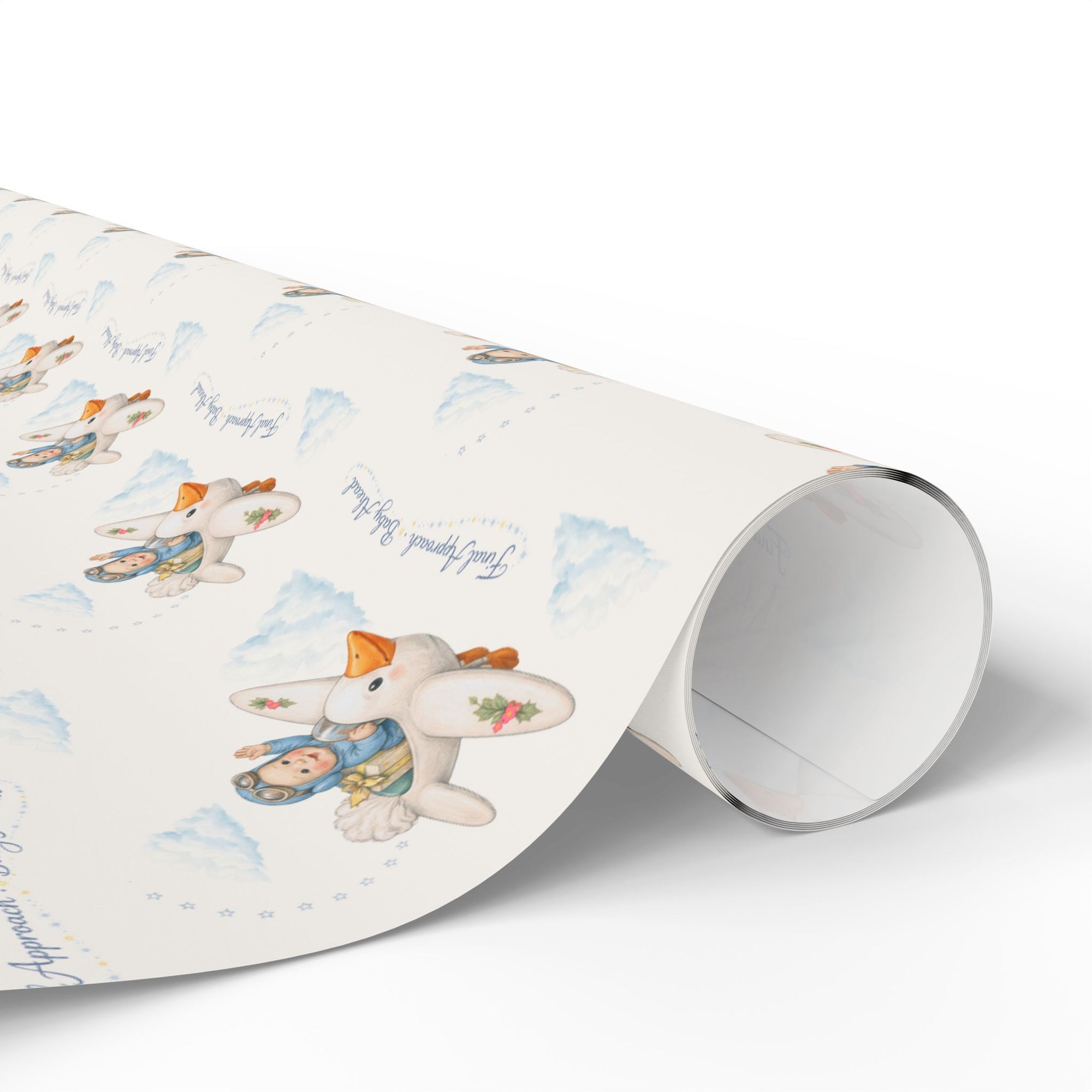 Roll of wrapping paper with baby and stork design on a white background