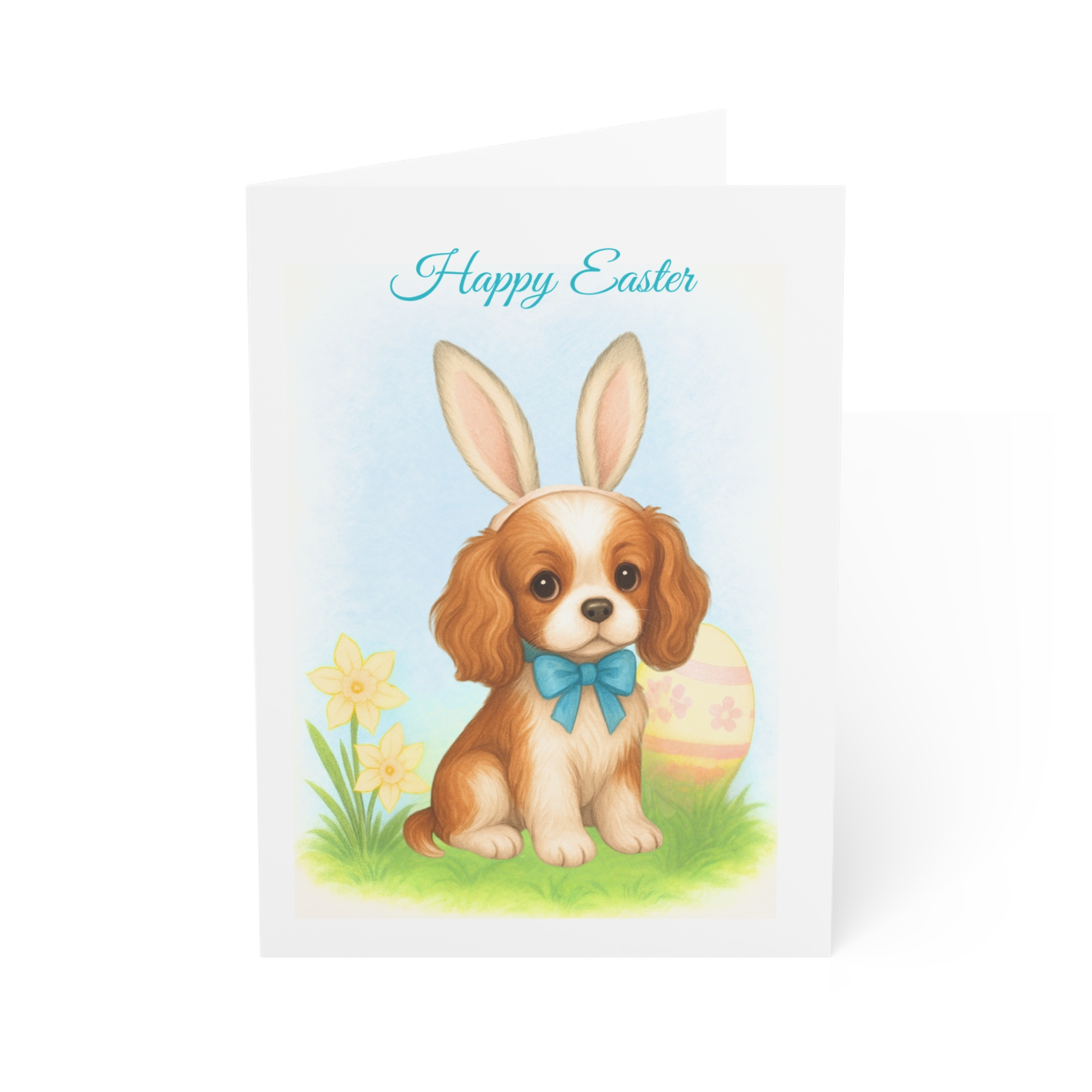 Easter card with a darling King Charles Cavalier Dog in bunny ears sitting by a daffodil and an easter egg.