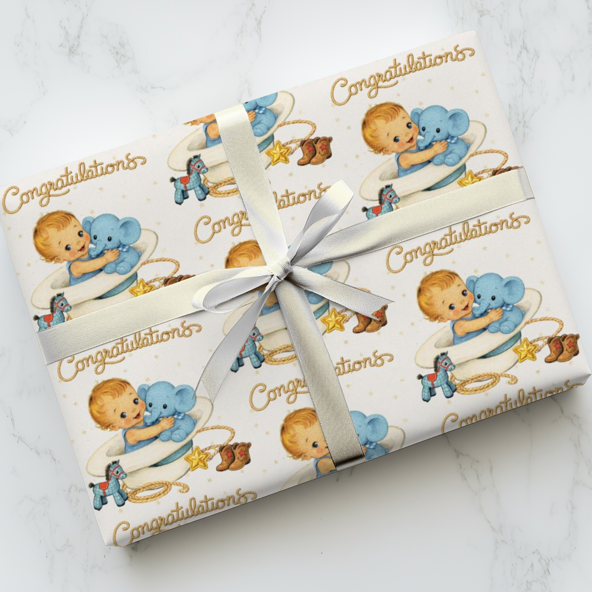 Gift wrapped in paper with western themed baby design and 'Congratulations'.