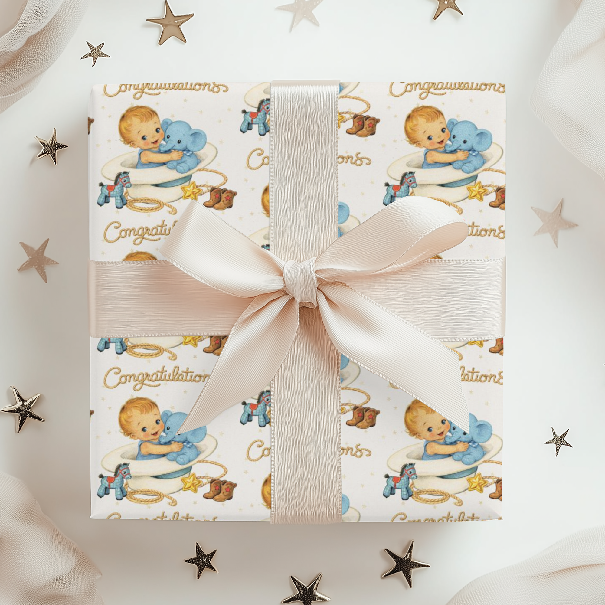 Gift box with cowboy baby-themed design and pink ribbon on a starry background
