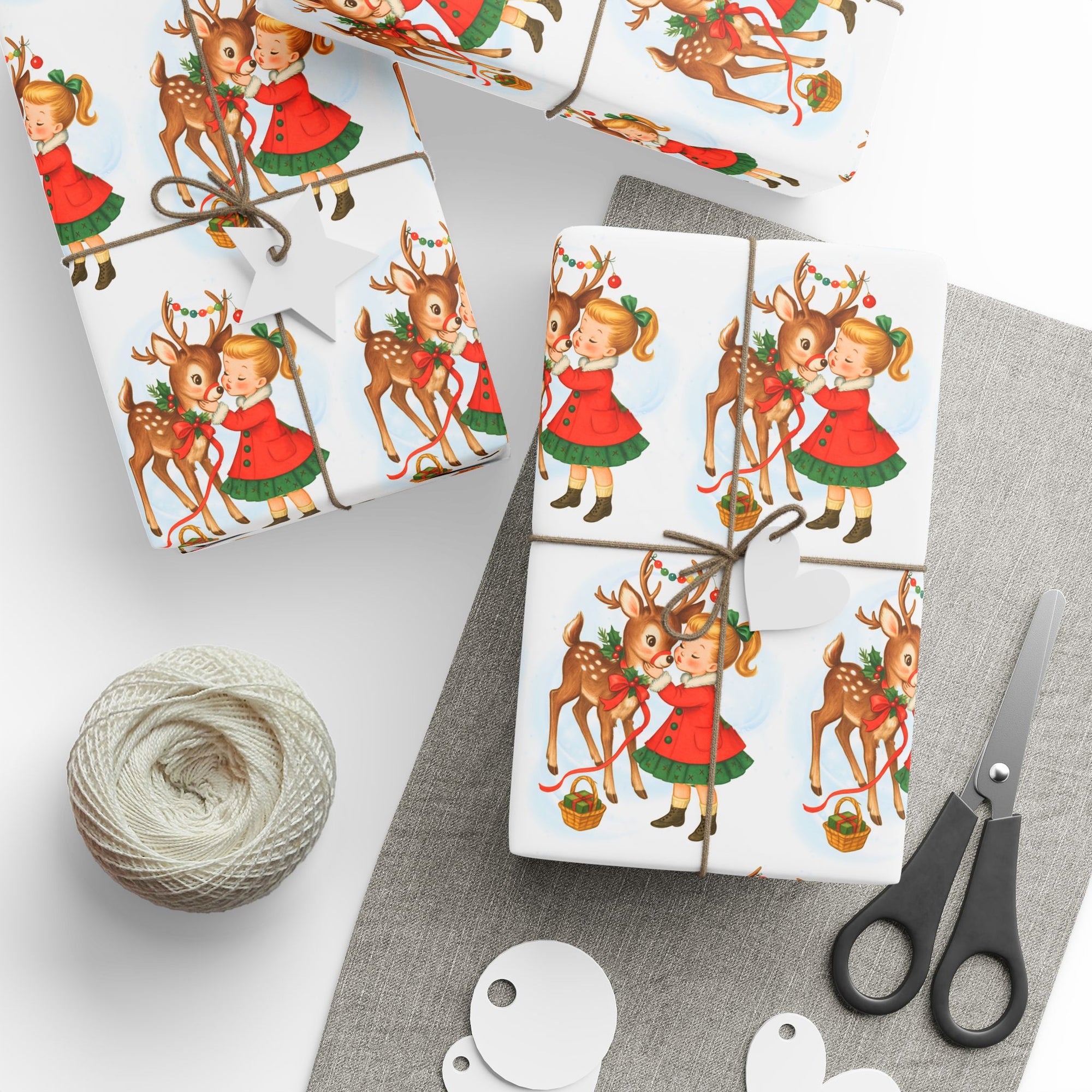 Christmas-themed gift wrap with reindeer and little girl kiss on a white background front view