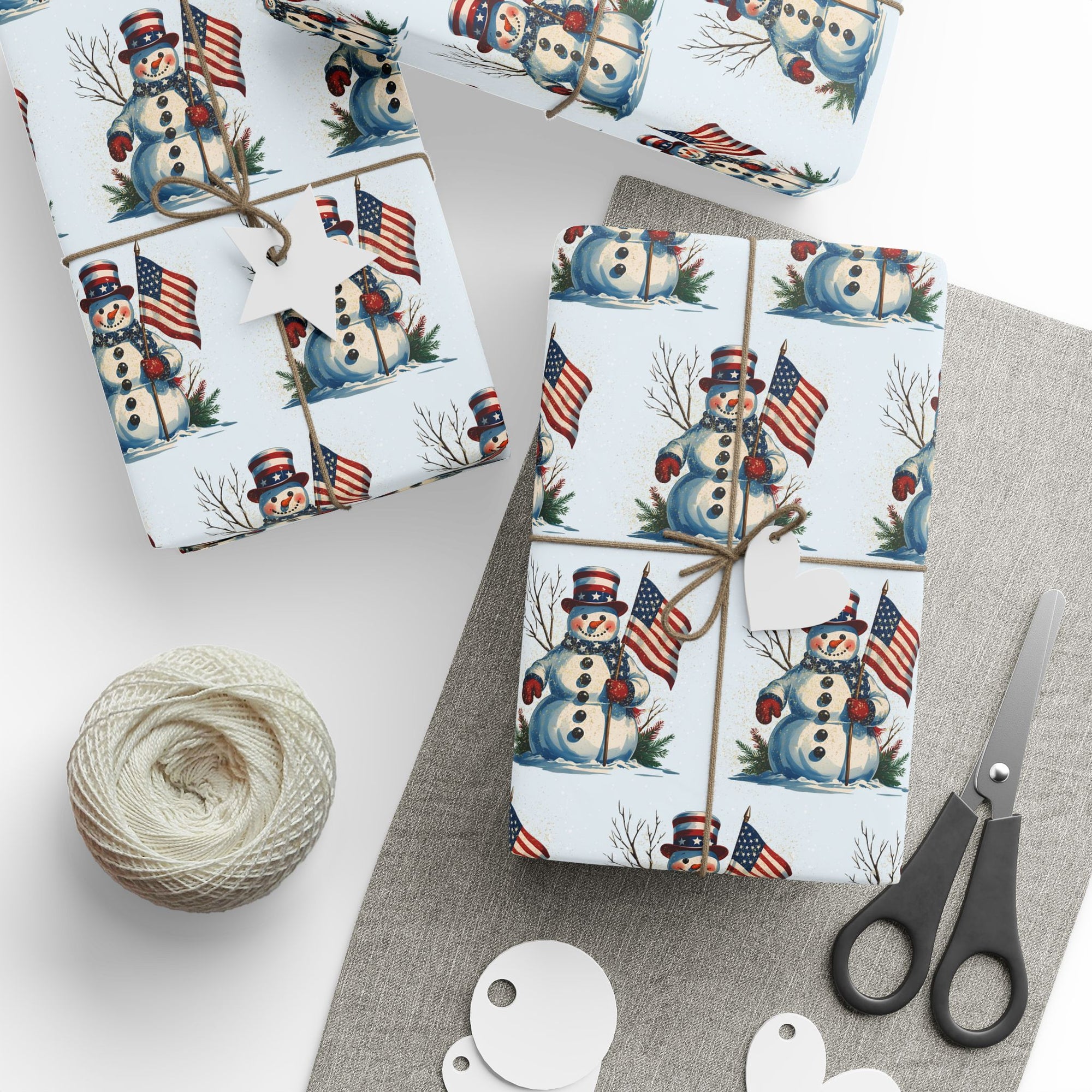 front view of wrapping paper that features snowman and american flag against a light blue background
