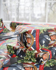 Patriotic Christmas wrapping paper with wreaths, stars, and stripes and 47th president side view