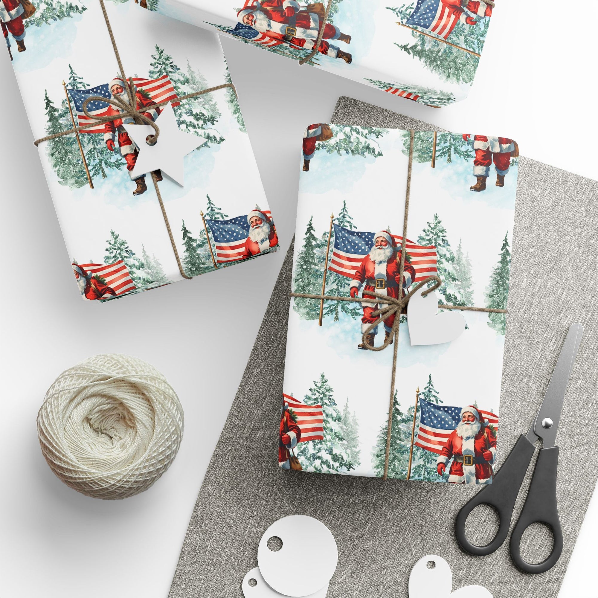 Christmas-themed gift wrap with Santa Claus and American flags on a table with scissors and twine