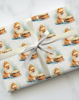 Gift wrapped in paper with pomeranian dog and birthday cake pattern.