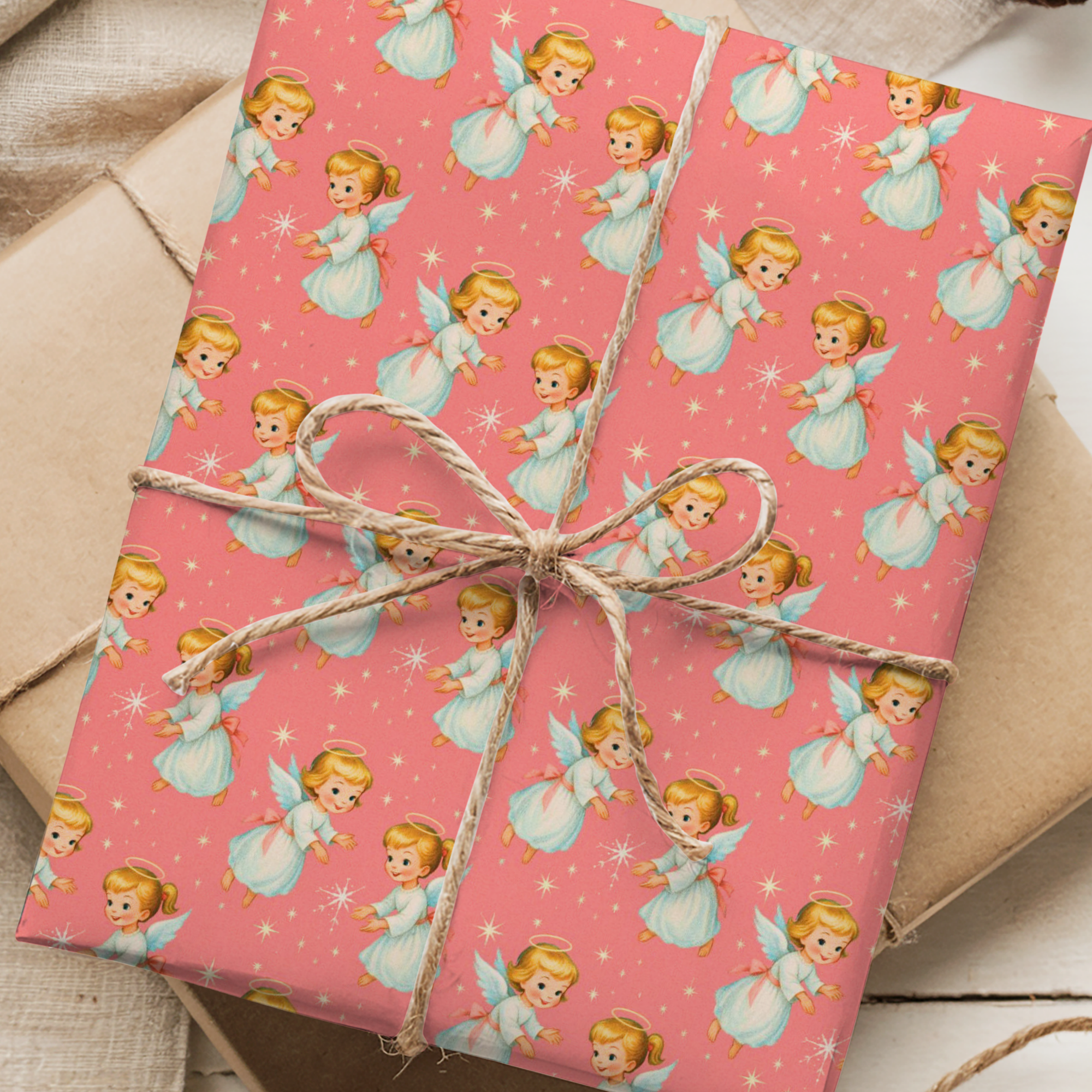 Retro Christmas angel wrapping paper storybook angels, white gowns, halos, and twinkling stars on a pink background.
