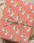 Retro Christmas angel wrapping paper storybook angels, white gowns, halos, and twinkling stars on a pink background.
