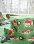 Christmas-themed gift wrap with snowmen and candy canes on a green background.