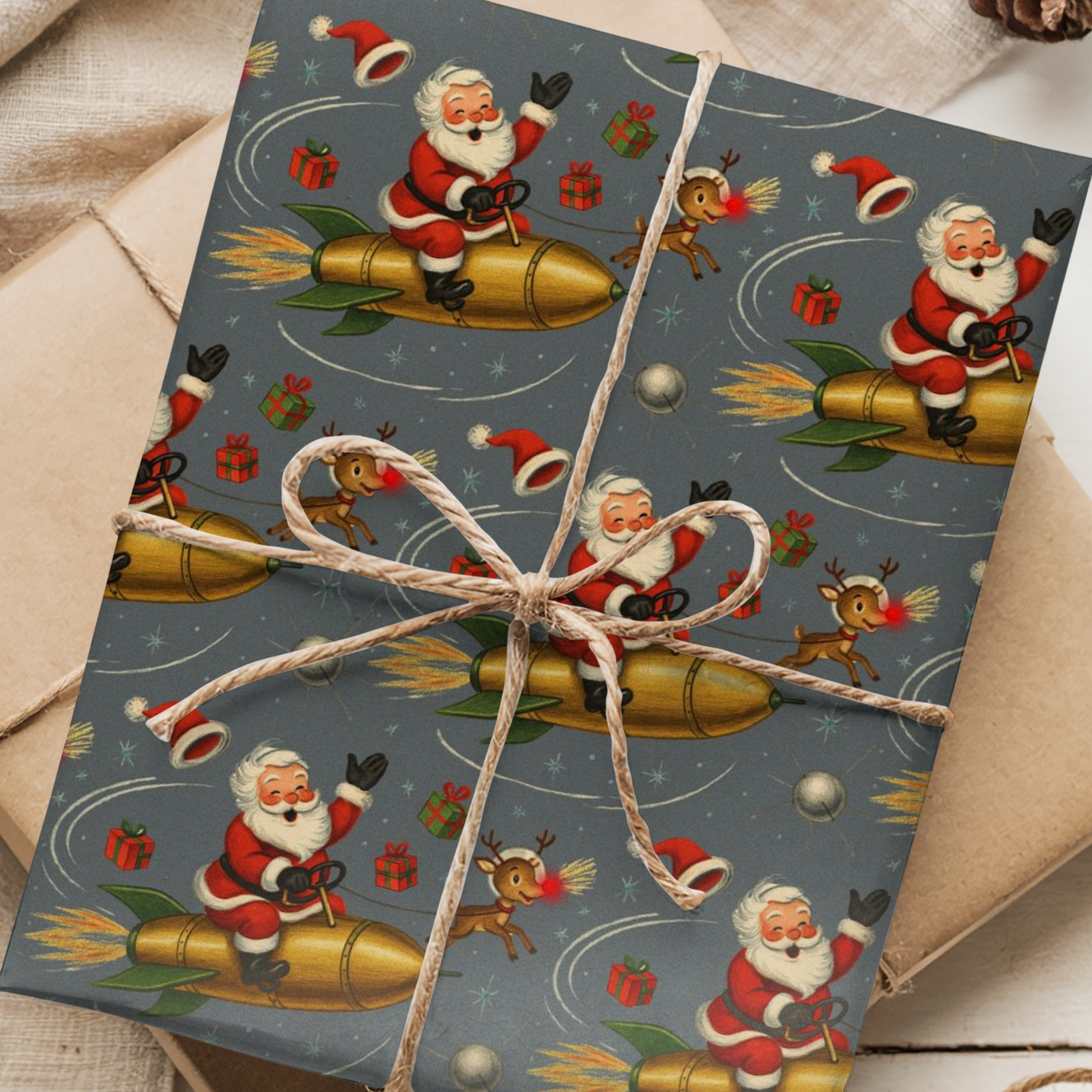 Christmas themed wrapping paper featuring Santa and rudolph riding a rocket through space ready to deliver presents.