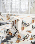 Gift boxes wrapped in paper with husky dog and cake pattern on a table.