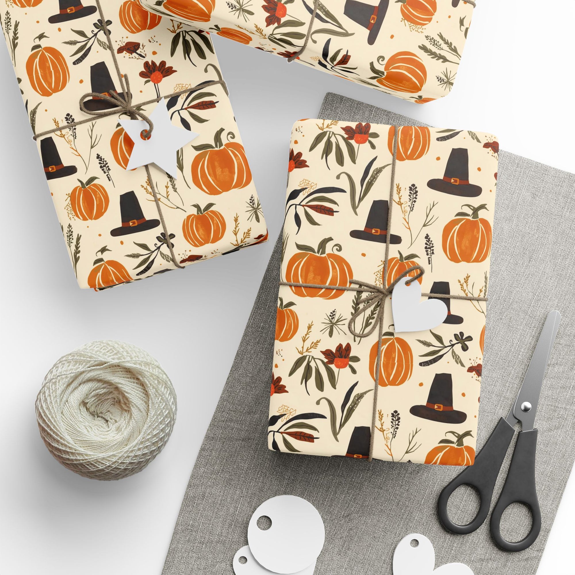 Gift boxes wrapped in autumn-themed paper with pumpkins, pilgrims, and leaves.