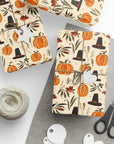 Gift boxes wrapped in autumn-themed paper with pumpkins, pilgrims, and leaves.