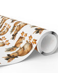 Roll of wrapping paper with bunnies dressed as pilgrims and leaf pattern on a white background.