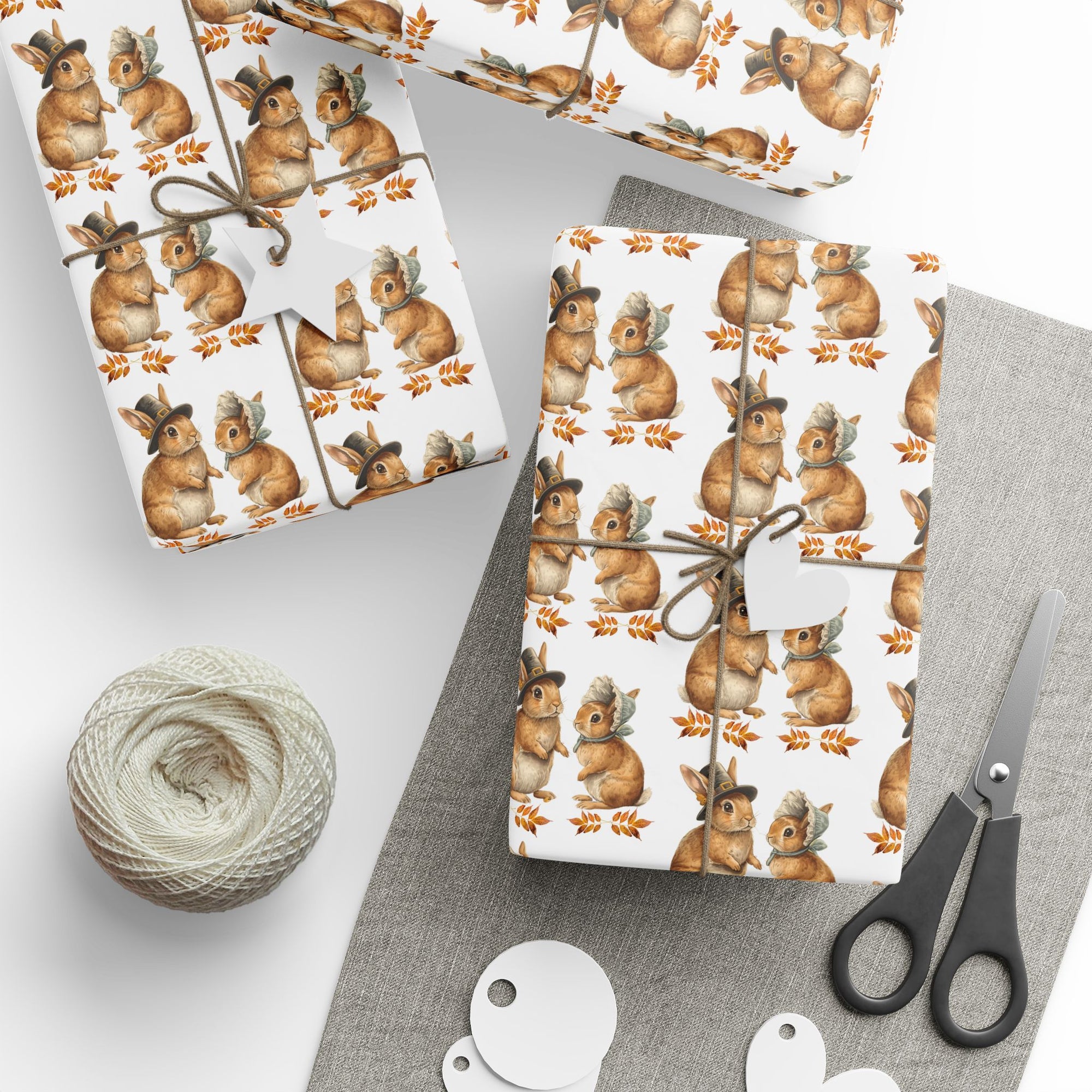 Roll of wrapping paper with bunnies dressed as pilgrims and leaf pattern on a white background.