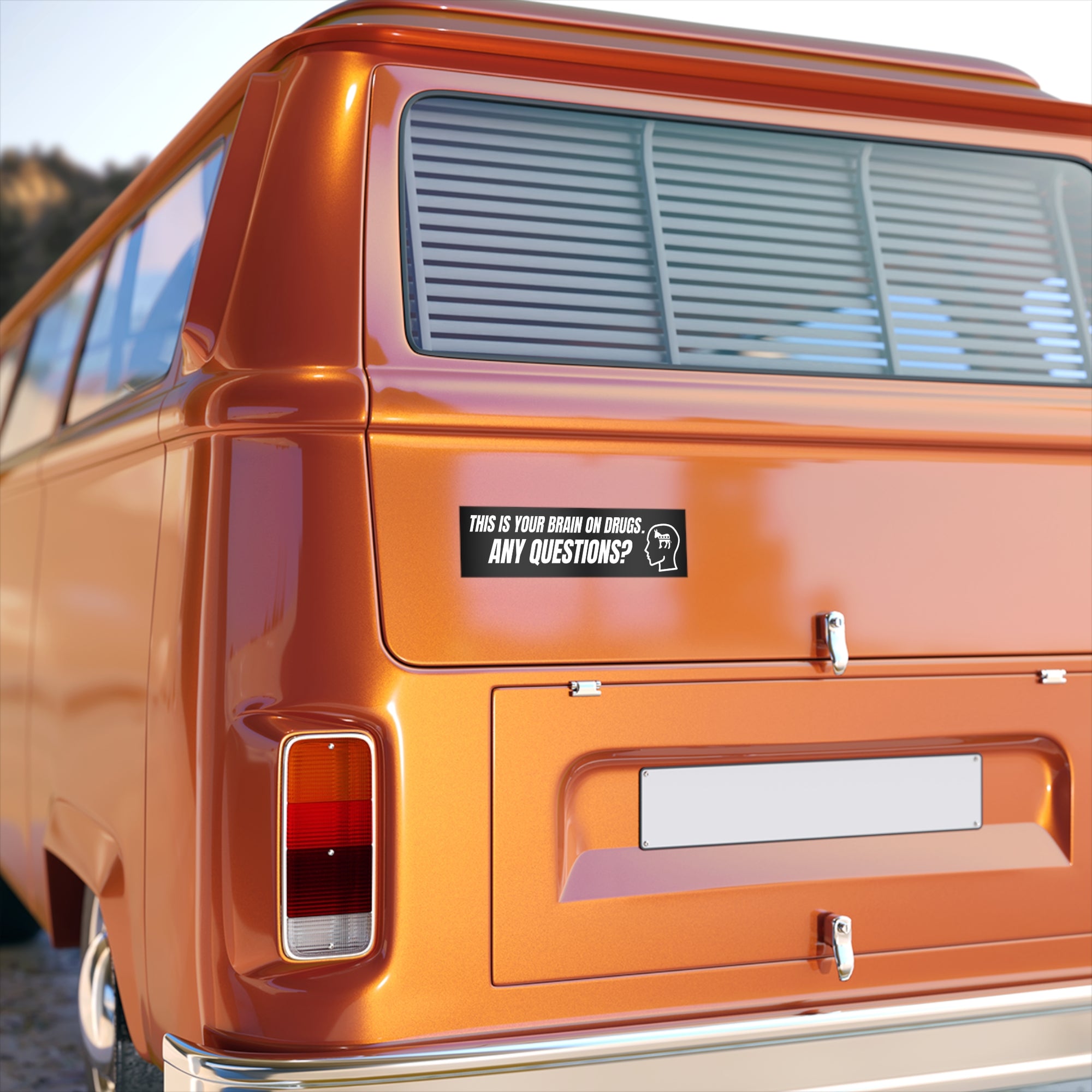 Orange van with a humorous sticker on the back
