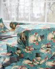 Stack of wrapped presents with snowman pattern on a table with scissors.
