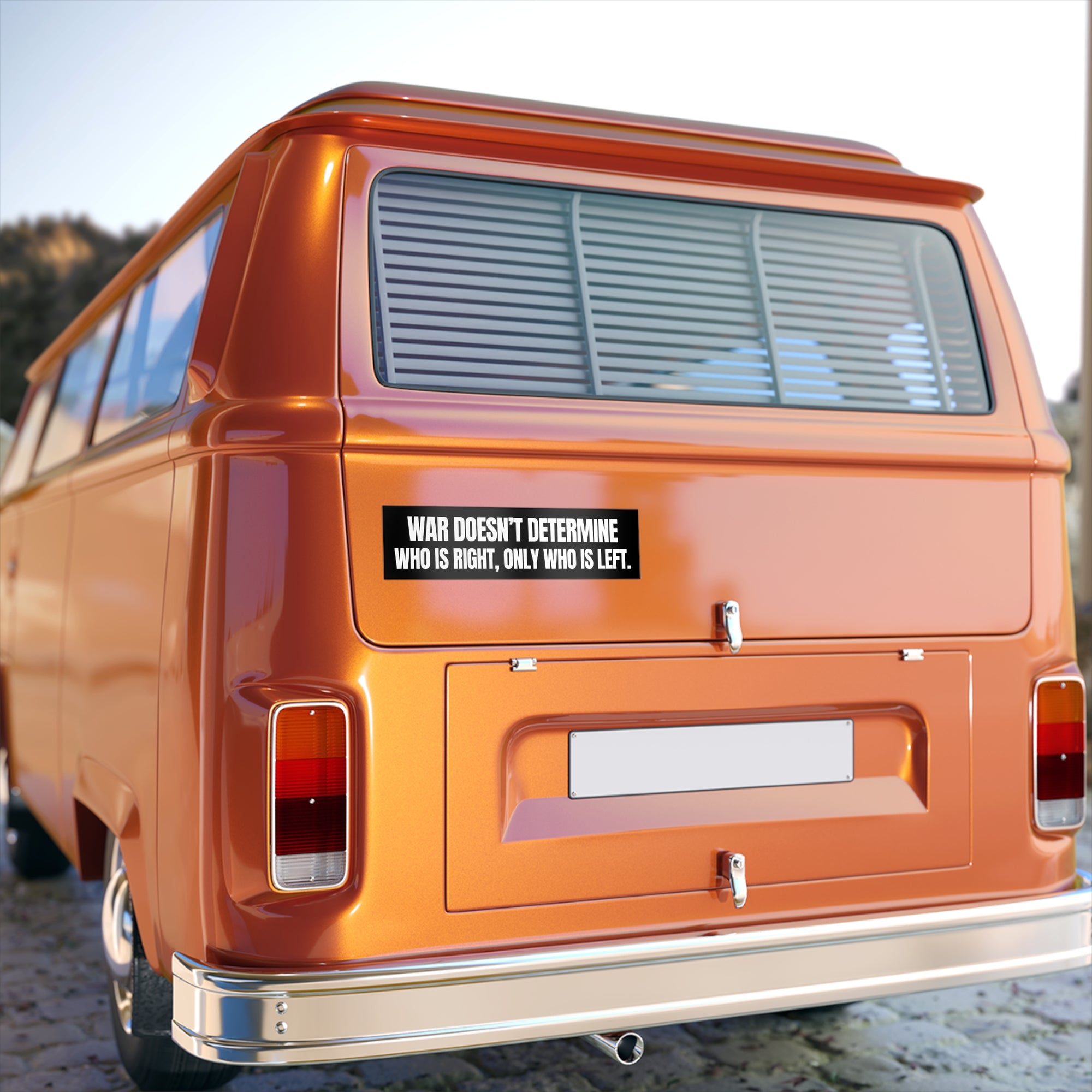 Orange van with a black bumper sticker on a blurred background