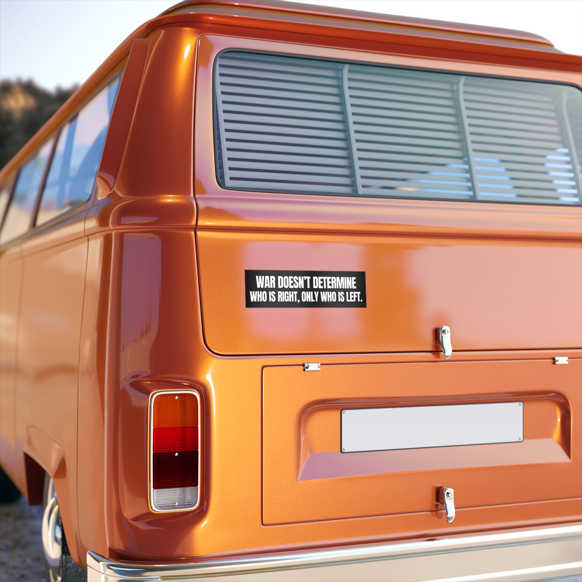 Orange van with a sticker on the back of a van