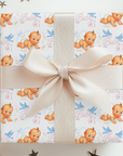 Gift box with baby-themed wrapping paper and a bow, surrounded by decorative stars.