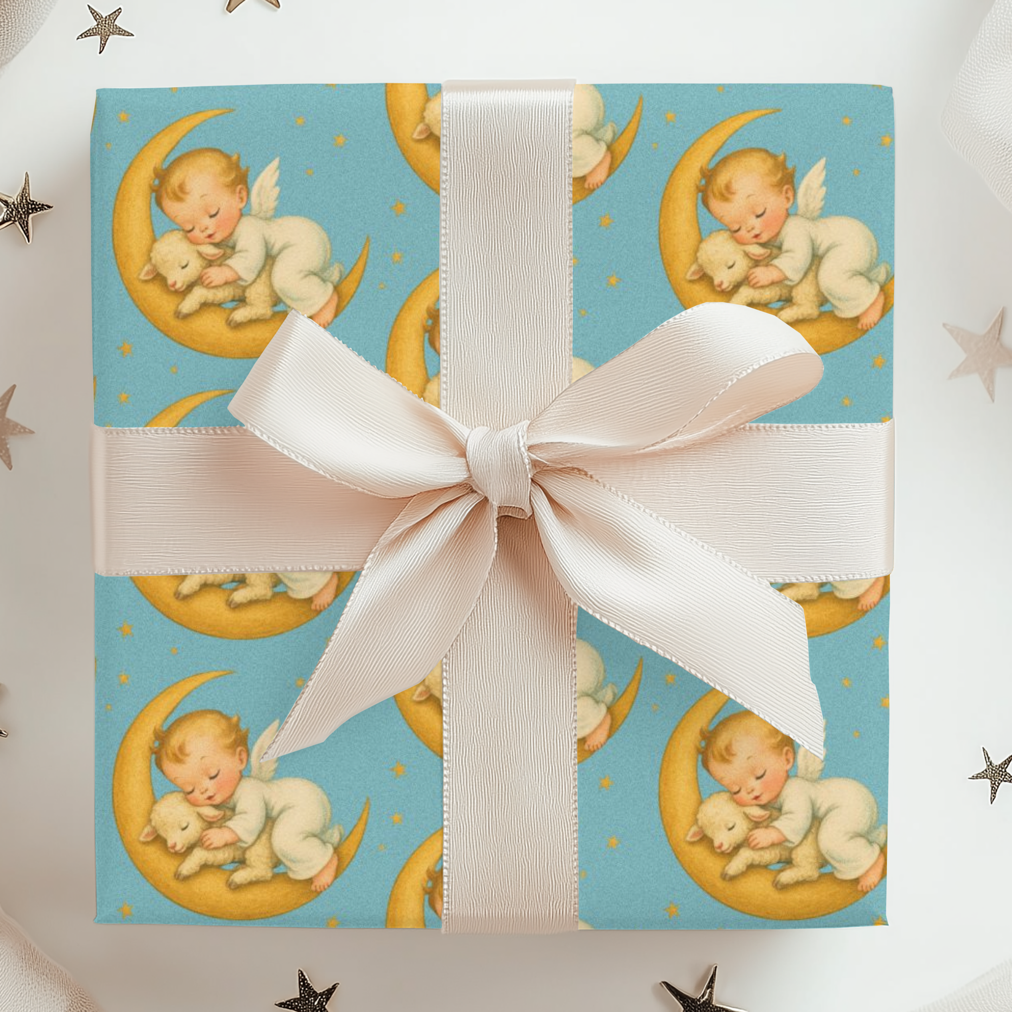 Gift box wrapped with new baby sleeping on a crescent moon design with a white ribbon on a white background.