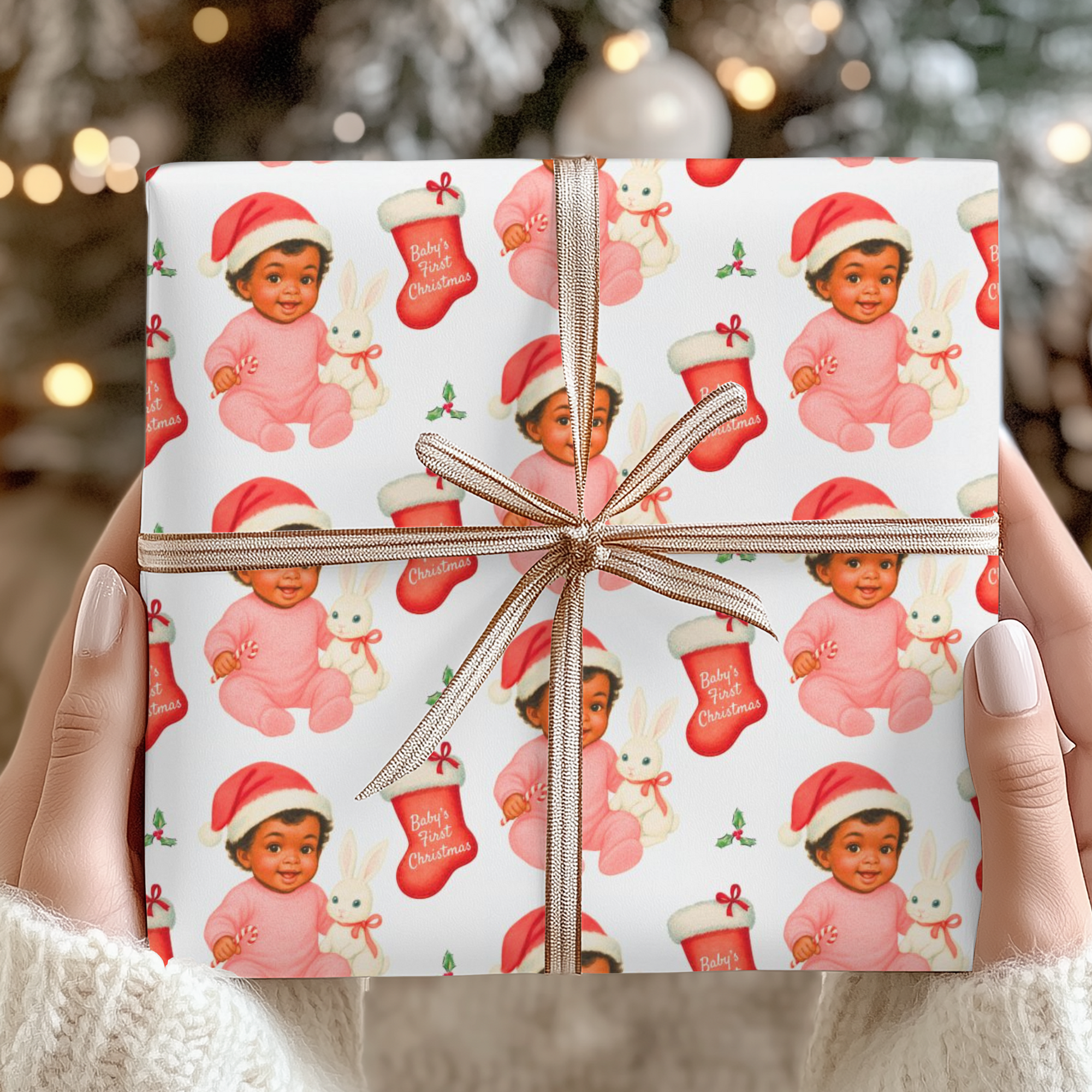 Christmas gift wrapped in babys first christmas wrapping paper with a design of a stocking and a cute baby in a santa hat