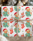 christmas packages wrapped in babys first christmas wrapping paper that includes a bunny and a little blonde boy with a santa hat.