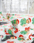 gifts wrapped in babys first christmas wrapping paper that has a sweet bunny and a little brunette baby boy in a santa cap.