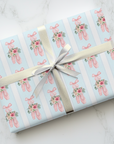 Rose Ballet wrapping paper with pink ballet slippers, frosted roses, and greenery on light blue background