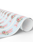Winter Rose Ballet wrapping paper with pink ballet slippers, frosted roses, and greenery on light blue background
