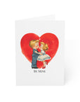Valentine's Day card with a couple kissing in front of a red heart and 'Be Mine' text.