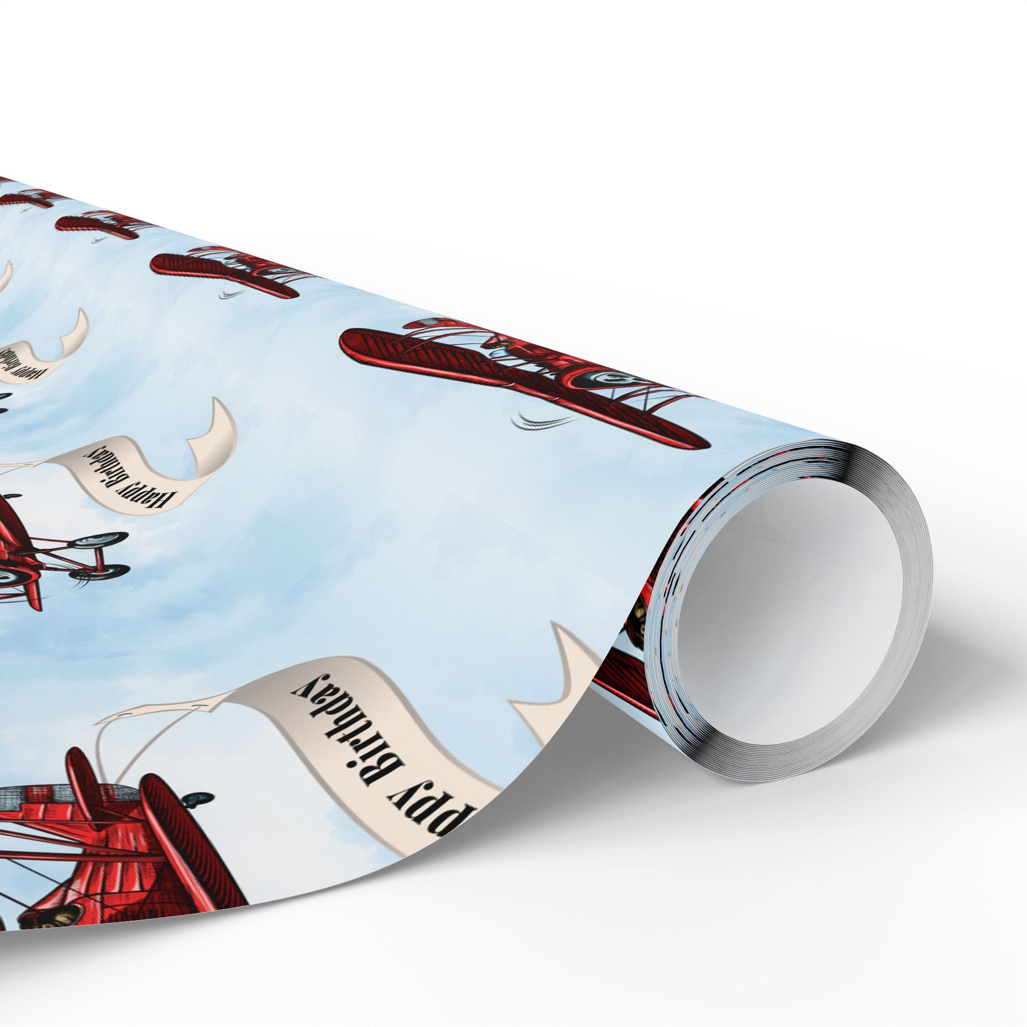 Wrapping paper featuring a classic red vintage biplane towing a cream-colored banner that reads “Happy Birthday”