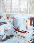 Wrapping paper featuring a classic red vintage biplane towing a cream-colored banner that reads “Happy Birthday”