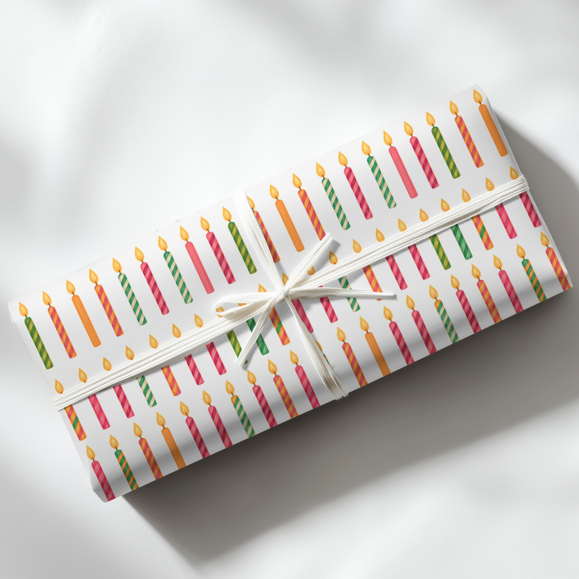 roll of wrapping paper featuring birthday candles in every color.