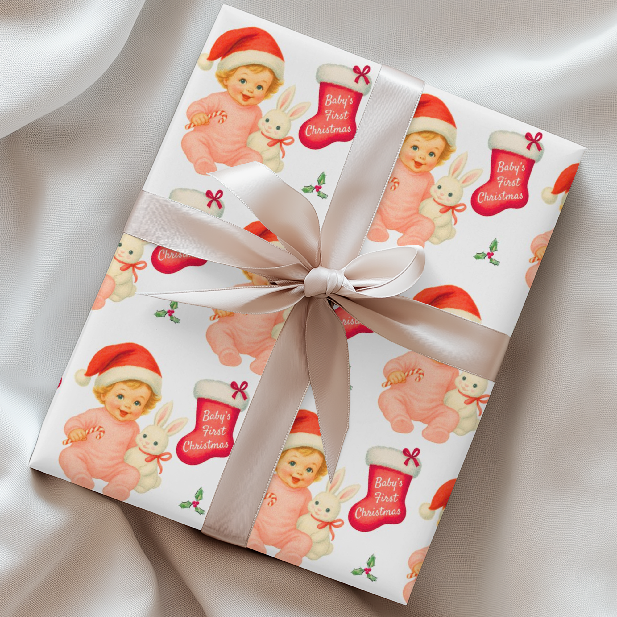 Vintage “Baby’s First Christmas” wrapping paper featuring a smiling blonde baby girl in a pink romper and Santa hat holding a white bunny plush and candy cane, surrounded by red Christmas stockings and holly, retro storybook illustration style.
