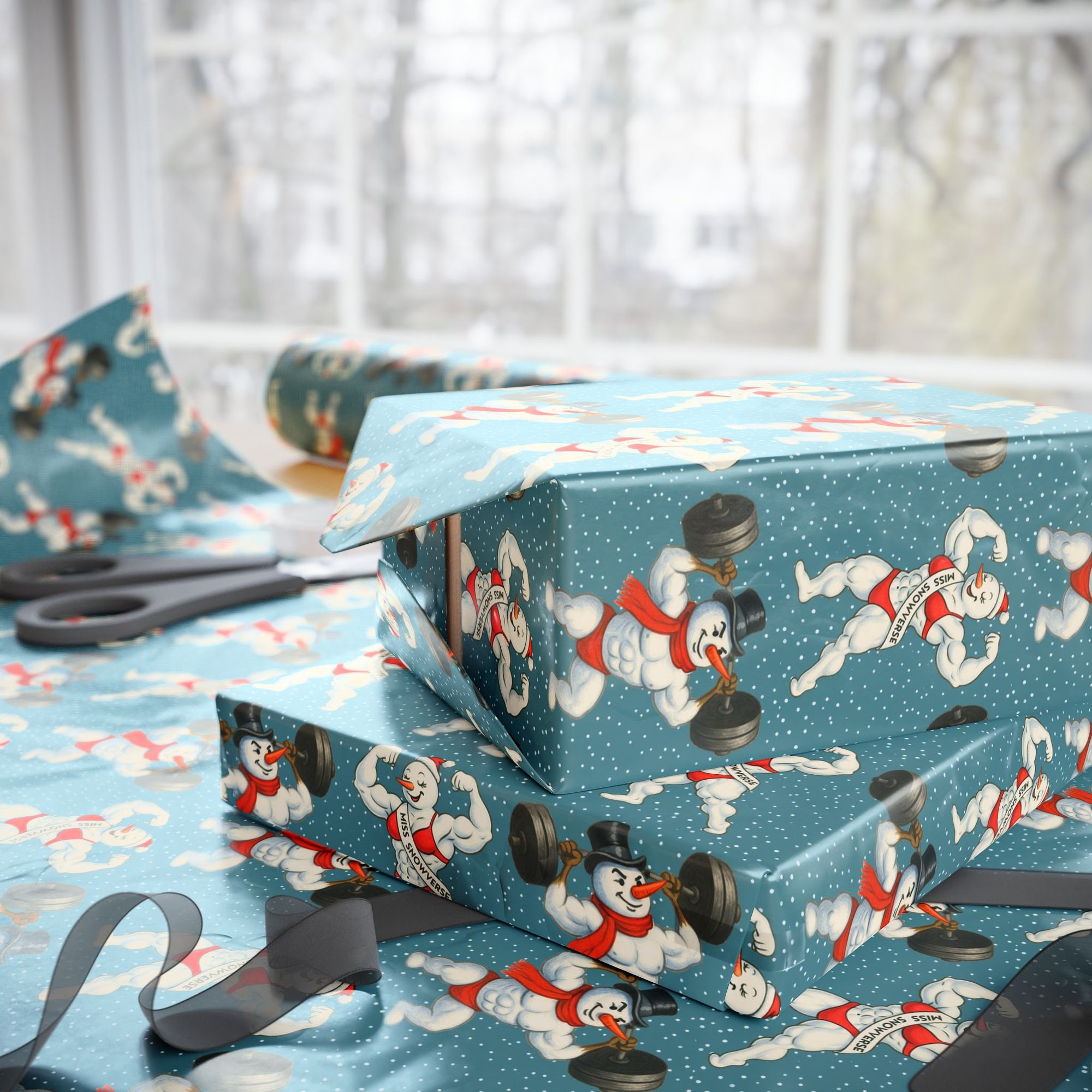 Gift boxes wrapped in blue paper with a humorous snowman design lifting weights, on a blue background.