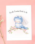 Bridal shower card “For the Tweetest Bride-to-Be” with bluebird bride wearing a veil perched on a blooming branch.