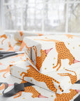 Gift box with cheetah print on a white surface with scissors.
