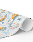 Roll of wrapping paper with baby, bluebird and cherry blossom design on a white background