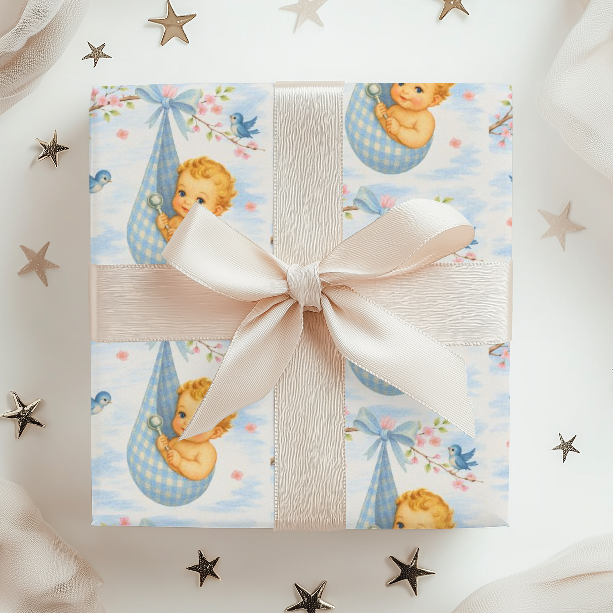 Gift box with baby-themed wrapping paper and a pink ribbon, surrounded by decorative stars.