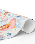 Roll of wrapping paper with baby and cherry blossom design on a light background