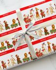 Roll of Christmas-themed wrapping paper with Santa Claus, giraffe, polar bear, snowman and reindeer parade.