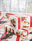 Roll of Christmas-themed wrapping paper with Santa Claus, giraffe, polar bear, snowman and reindeer parade.