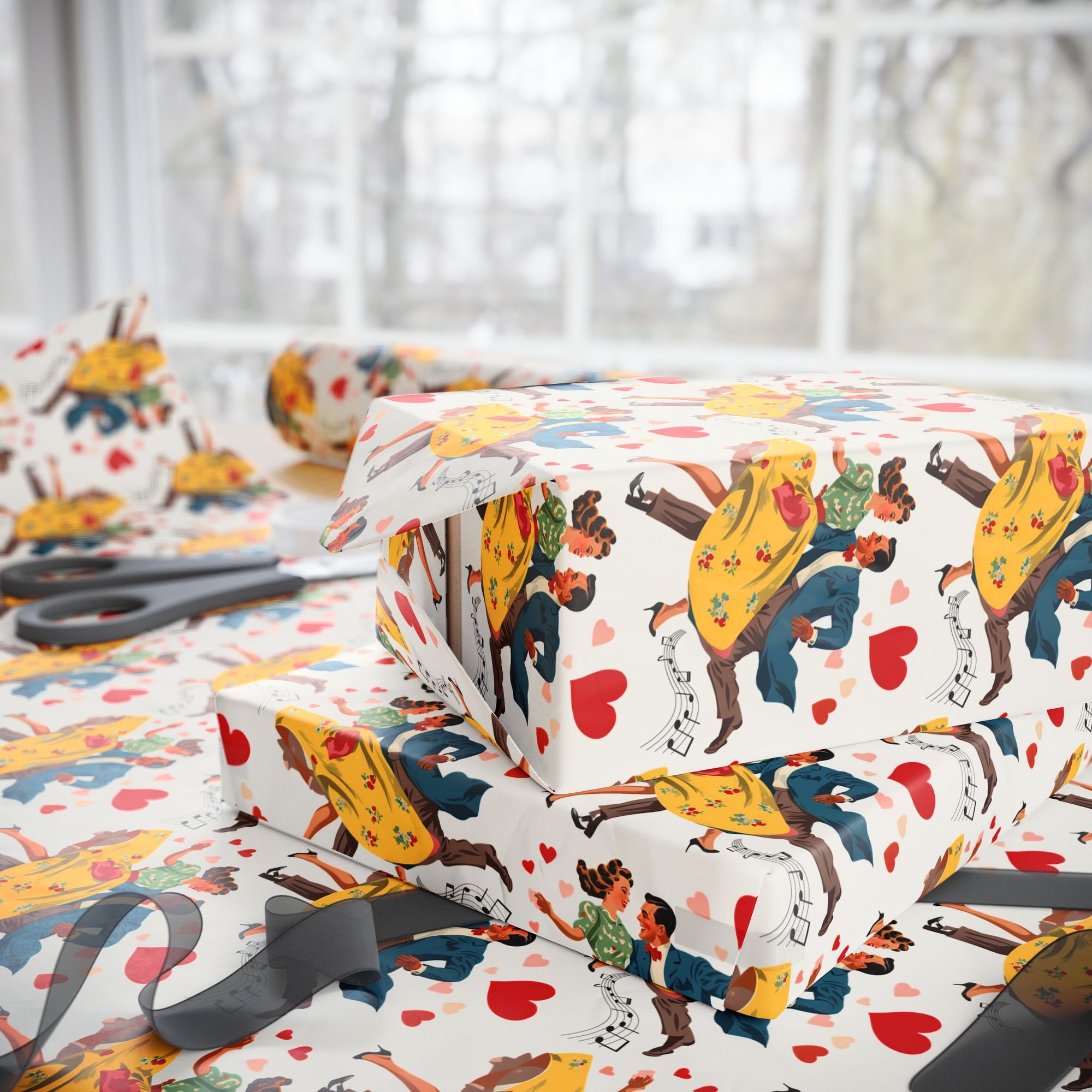 Gift wrap with colorful designs of people and hearts on a table with scissors.